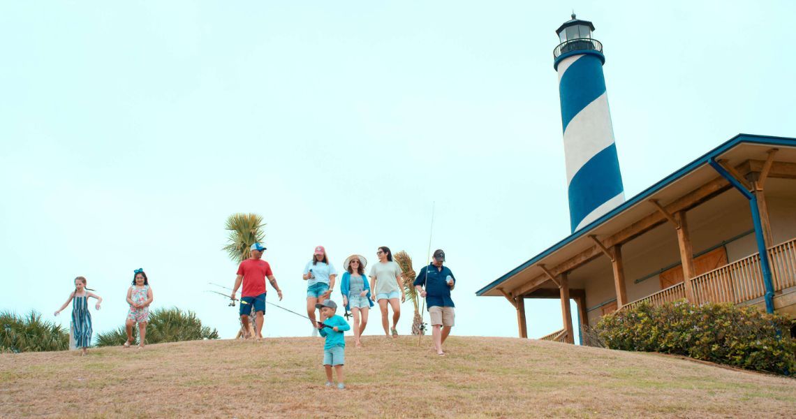 family walking down hill to go fishing