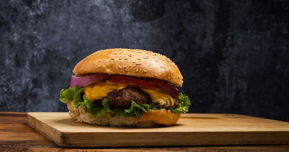 Cheeseburger on cutting board