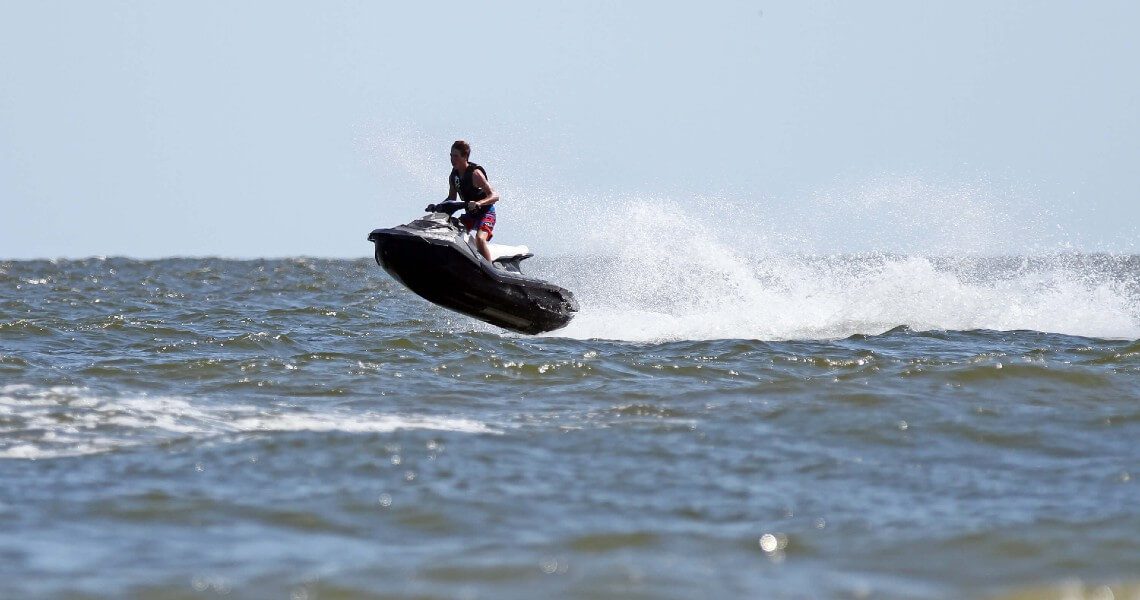 the-ultimate-guide-to-palacios-bay-beach-jetski-3 Jetskiier in the water at Palacios Bay Beach