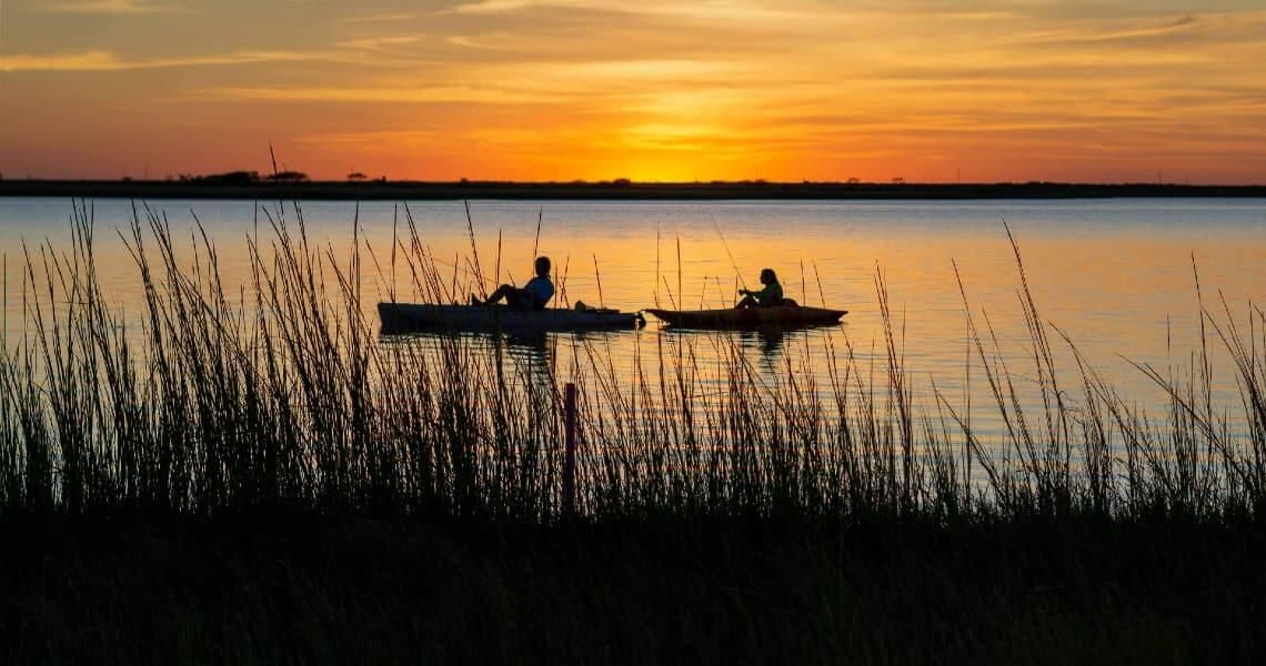 People kayaking at sunset