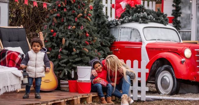 A festive Christmas scene featuring a family with two children.