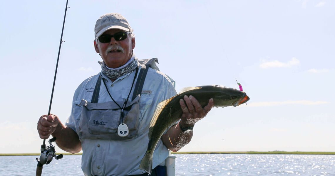 beachside community: your coastal retreat-man holding fish-7 beachside community: your coastal retreat-man holding fish-7