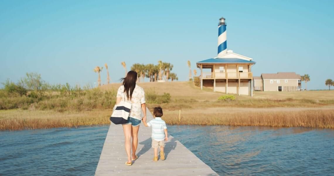 beachside community: your coastal retreat-woman and kid on pier-4