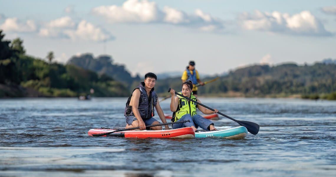 local guide to paddleboarding in palacios-couple sitting on paddle board-4